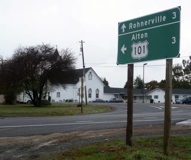 Green guide sign on wooden posts at a rural junction, 2013: Rohnerville 3 ahead, Alton 3 left, with a US 101 shield